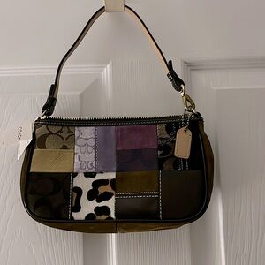 Coach wristlet/clutch shades of brown. 9 1/2”Wx5 1/4 H by 2” thick. Brand new